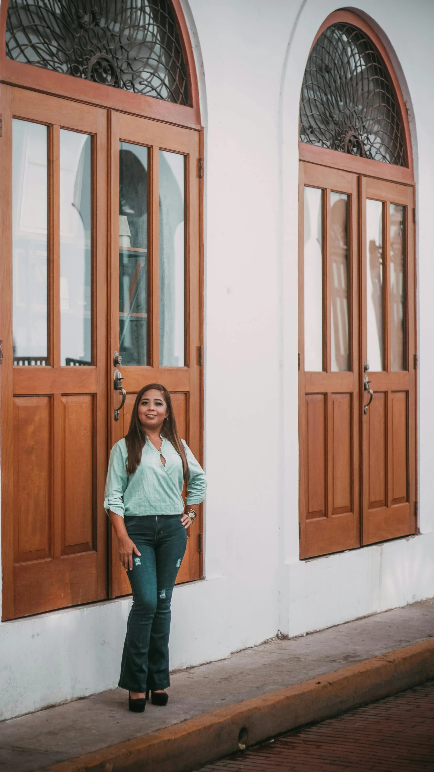 a woman standing in front of two doors