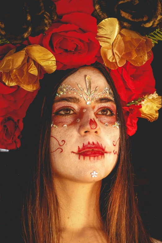 a woman with makeup painted like a skeleton and roses