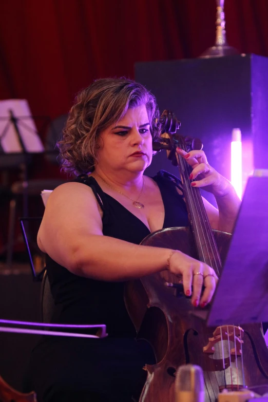 a woman playing the violin at a party