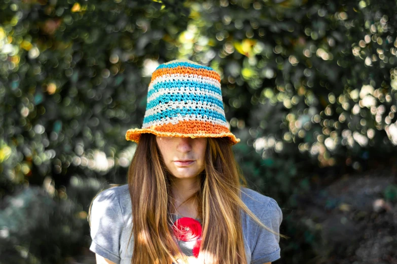  wearing striped hat in outdoor setting