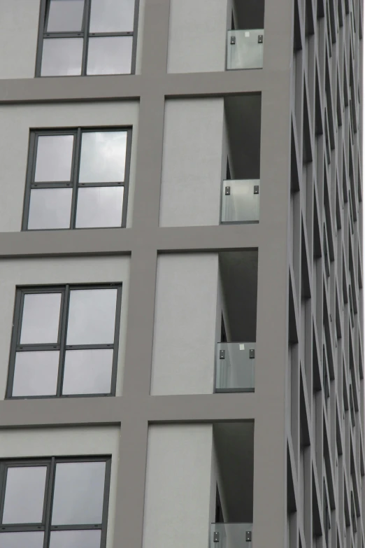 a clock in a window is on the side of a tall building