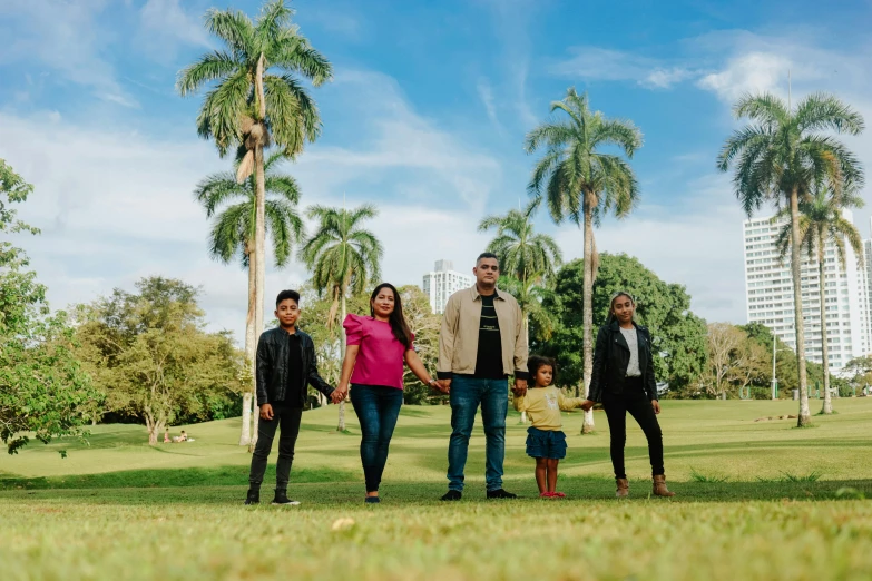 a group of people standing next to each other on top of a field