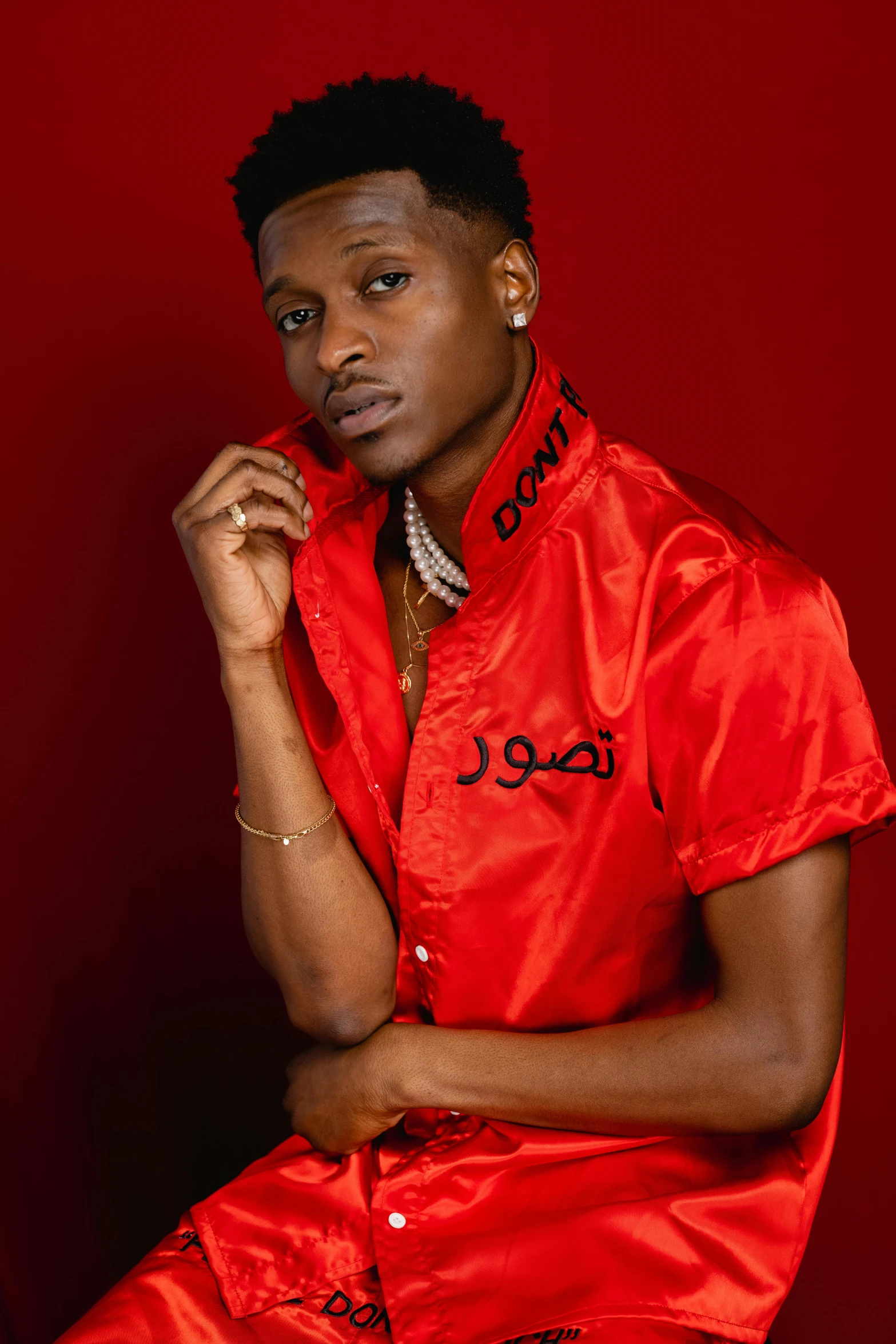 a man posing for a picture in a red shirt