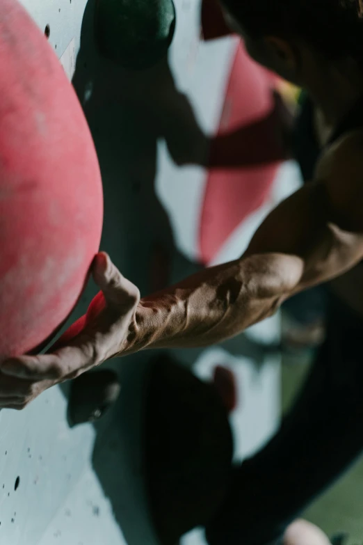 a person on a climbing board on a rock wall