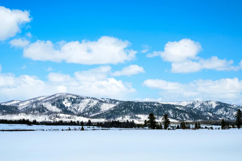 mountains covered in snow on a partly cloudy day