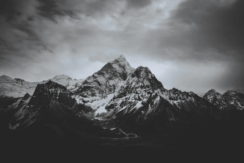 a dark sky and some large mountain tops