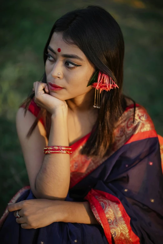 beautiful indian woman with an intricate red and blue outfit and jewelry