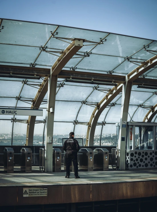 the man is standing at the platform with luggage