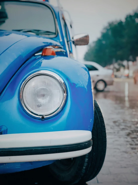 the blue beetle is parked in the parking lot