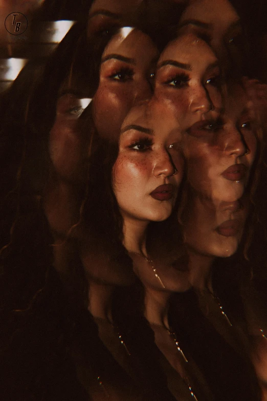 three women are seen through a mirrored glass