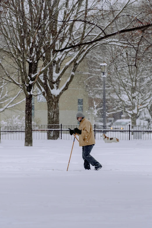 a man that is walking in the snow with skis