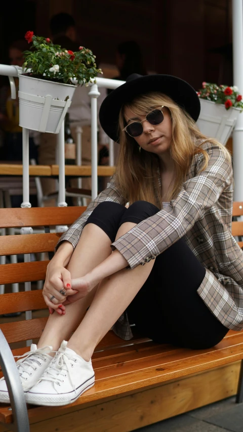 a woman sitting on a bench in the sun