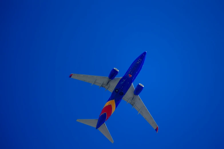 an airplane flying in a clear blue sky