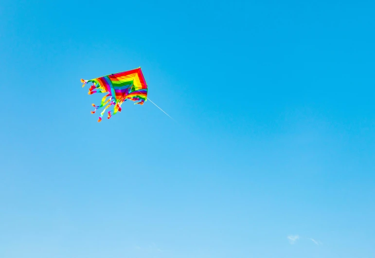 colorful kite flying in the sky on clear day