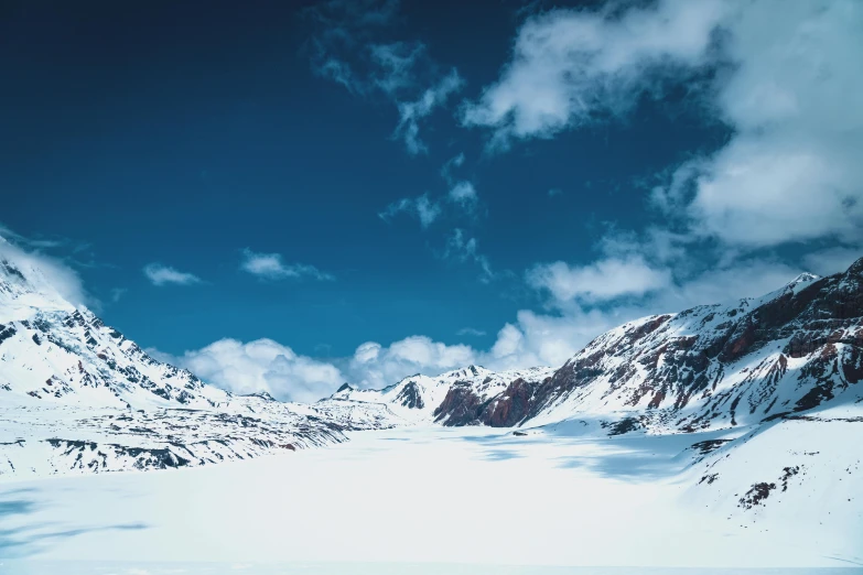 a mountain is shown with some clouds in the sky