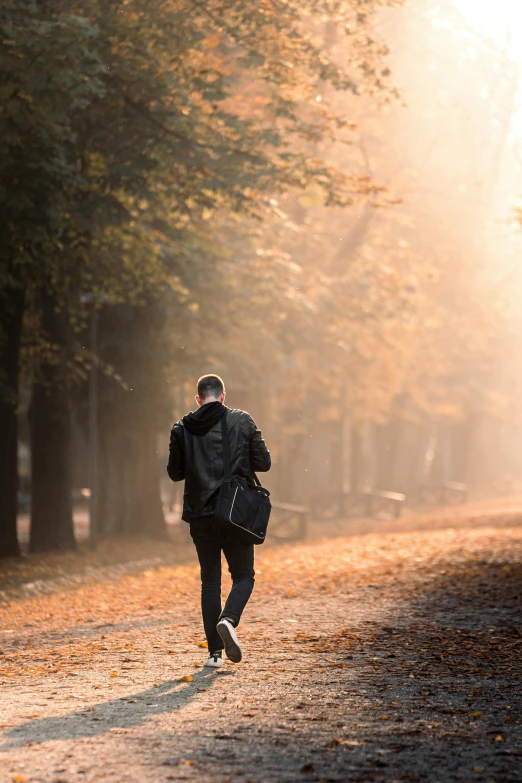 a man jogging down a street in the fall