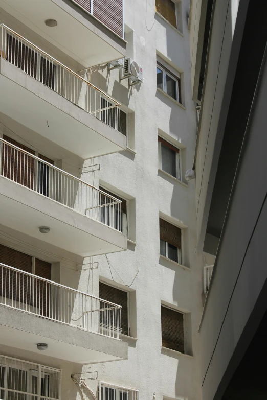 a white building with a balcony and balconies