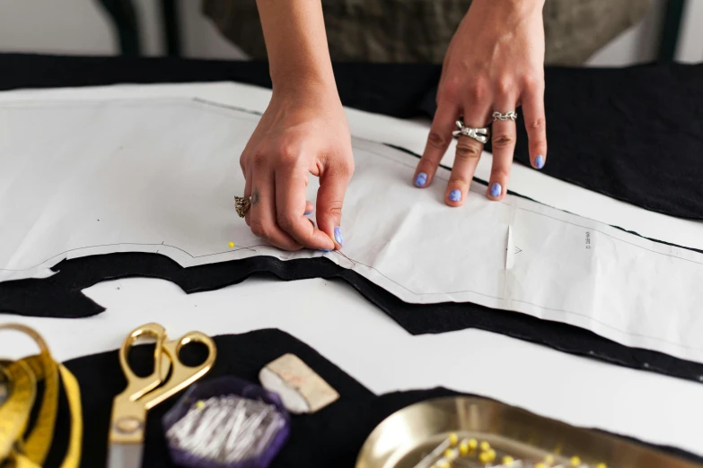 a woman  fabric and working on a dress