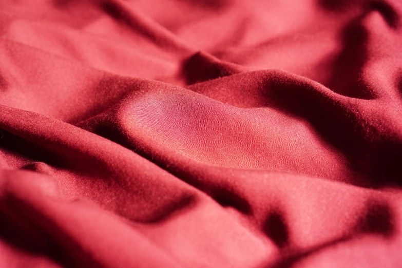 close up po of a red cloth with a texture