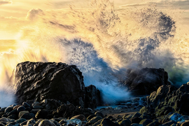 the large rocks are next to the waves