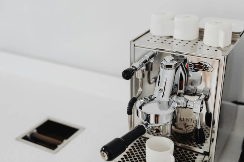 a silver espresso machine sitting on top of a counter