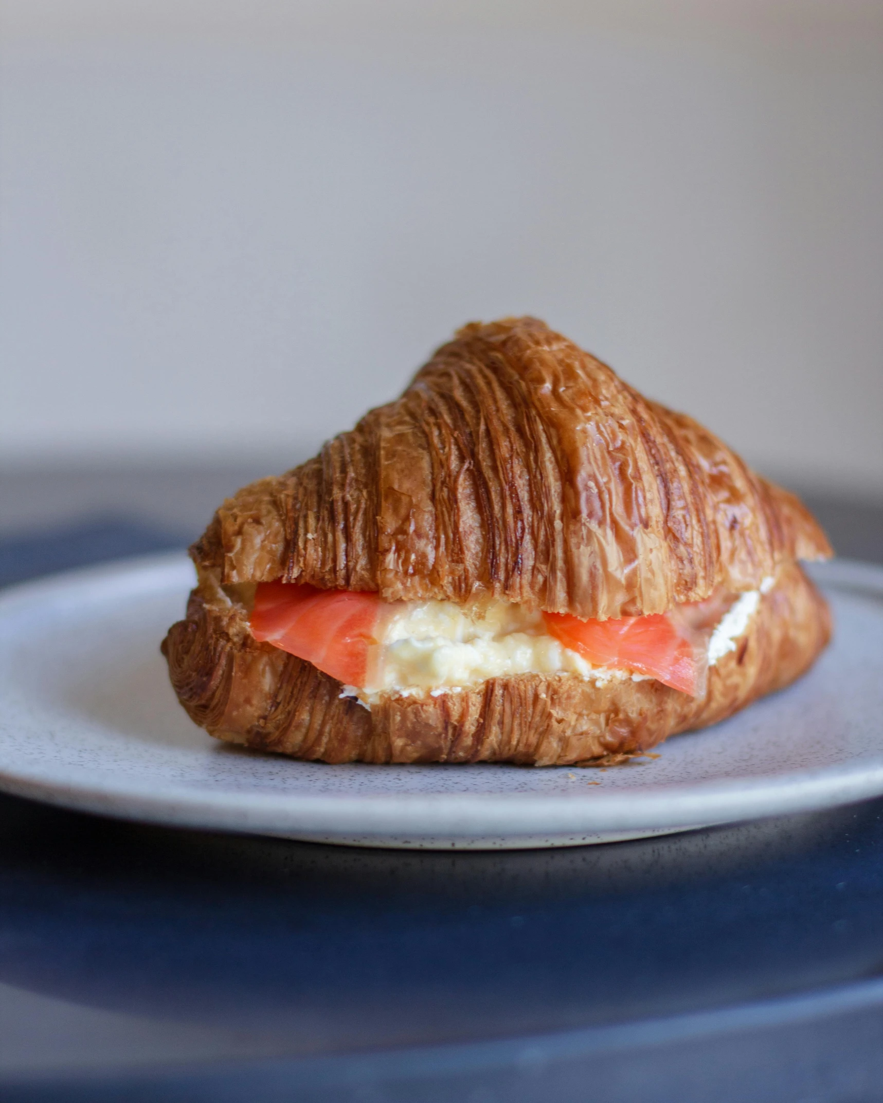 a croissant has cheese and tomatoes on it