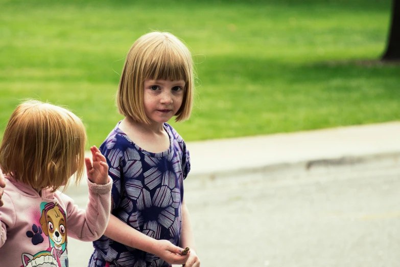 two s standing on the side of a road