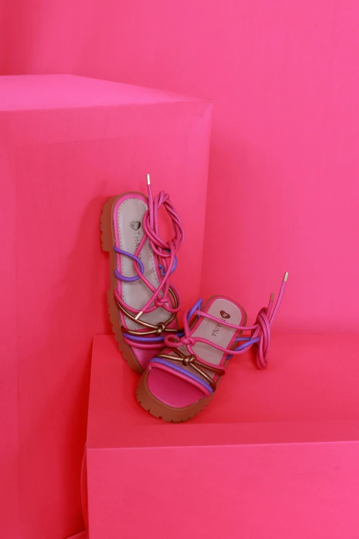 a pair of pink sandals and a pink box