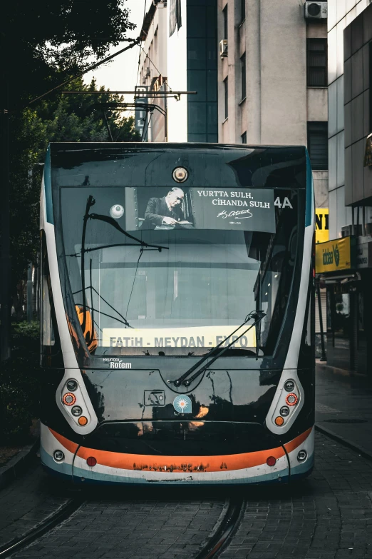 the metro train is traveling down the street