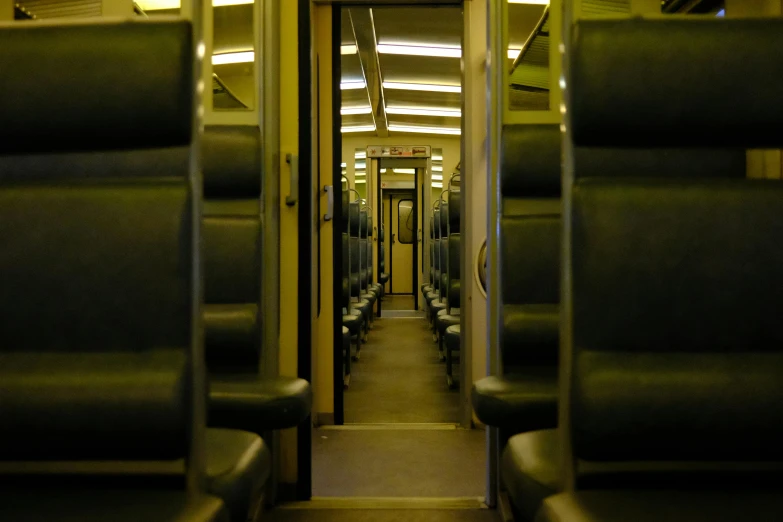 inside of a commuter train looking down the aisle