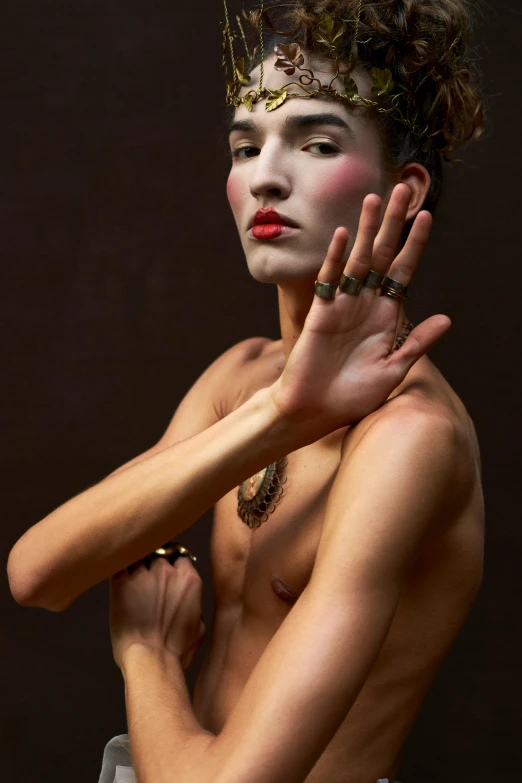 a very artistic picture of a woman wearing rings and gold jewelry