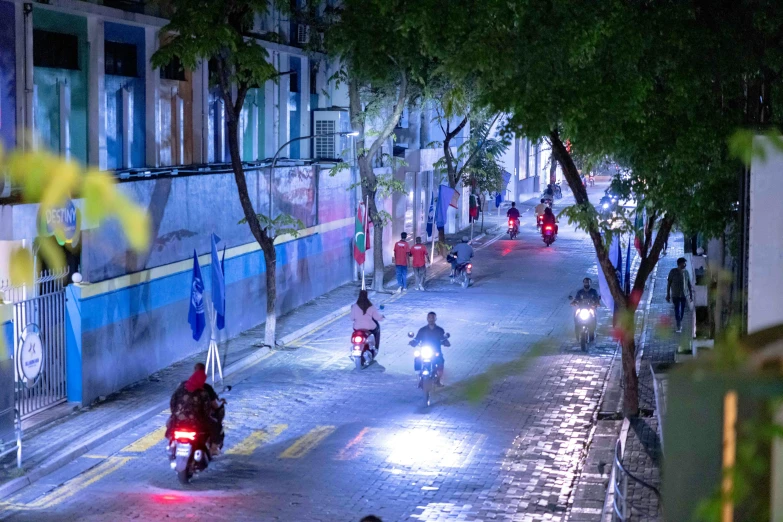 people riding motorcycles down the middle of a busy street