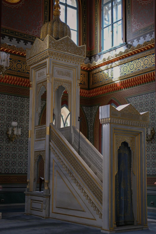 an ornate room that looks very nice and has a stair case