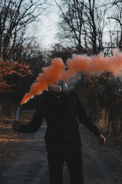 a man wearing a gas mask in the street with smoke