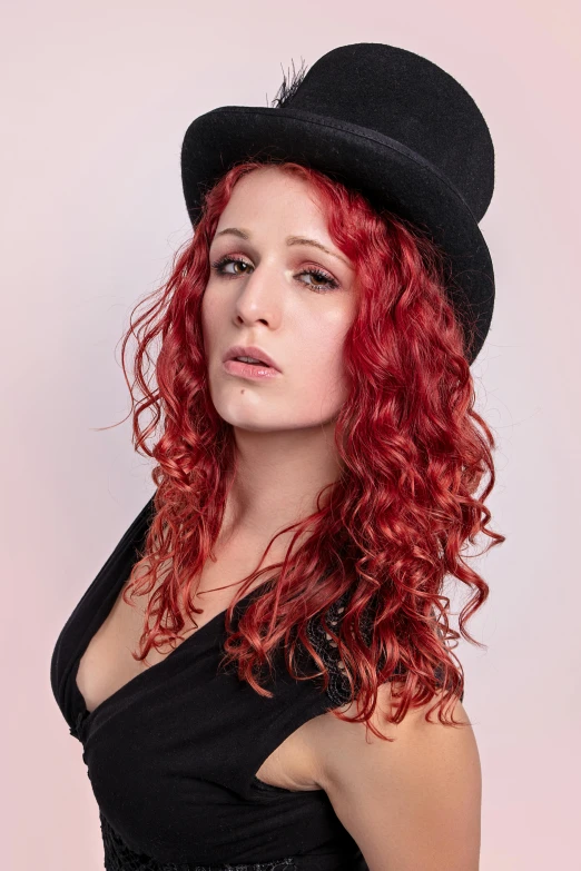 a pretty young red haired woman wearing a hat