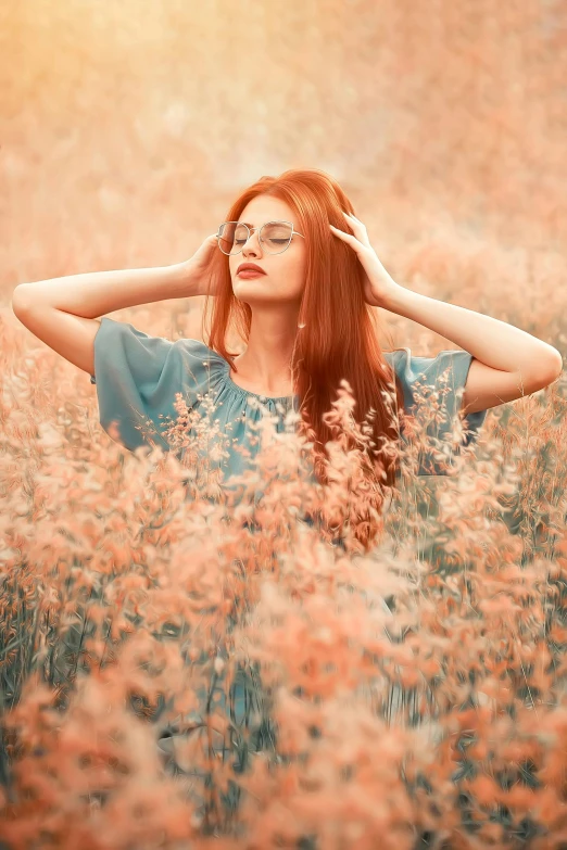 the girl is sitting in a field full of tall grass