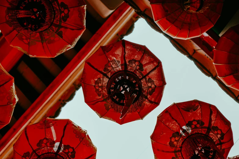 a lot of red umbrellas on a white surface