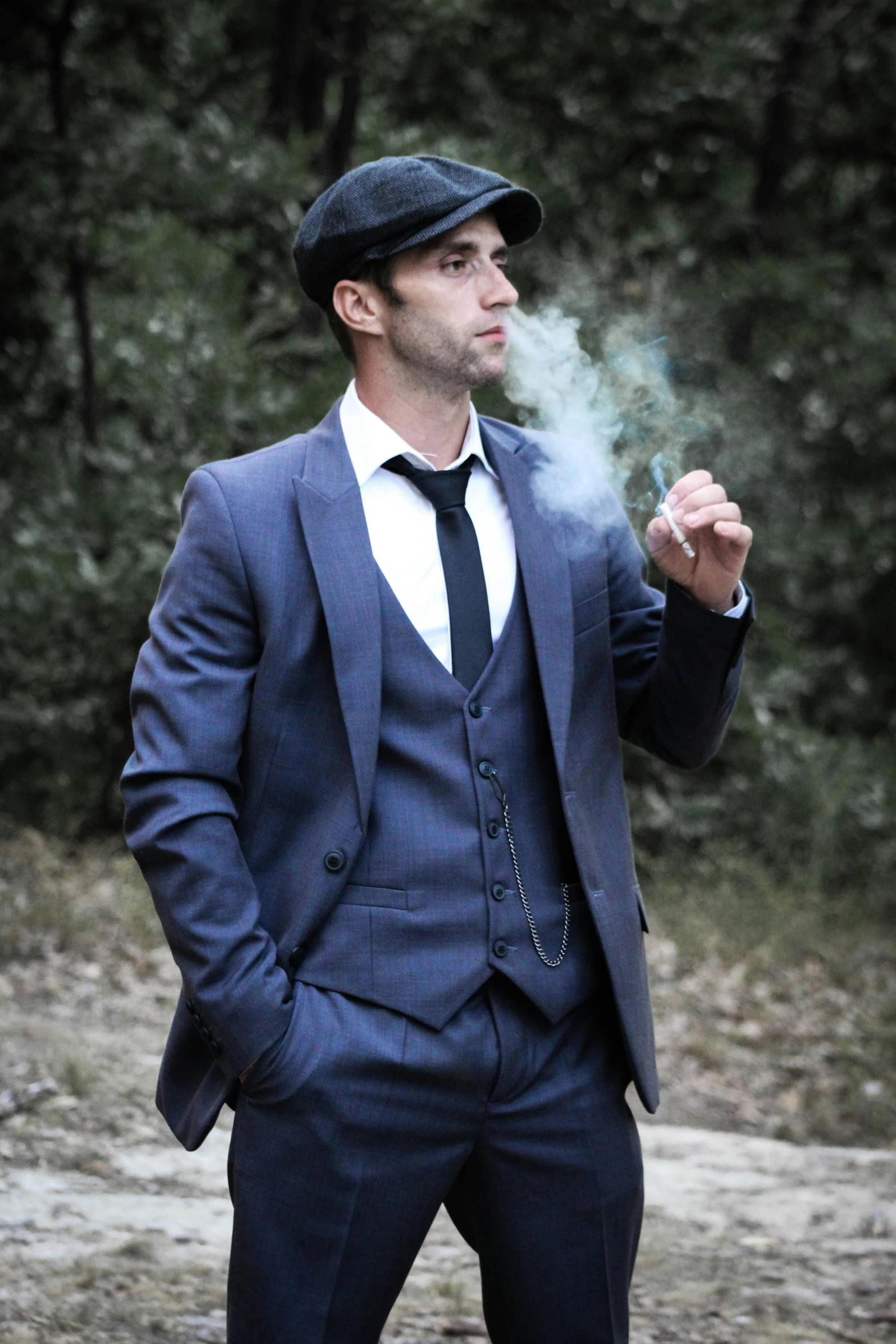 a man with a suit on holding a cigarette