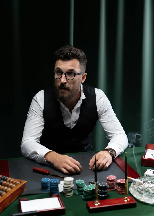 man sitting at table with some poker cards