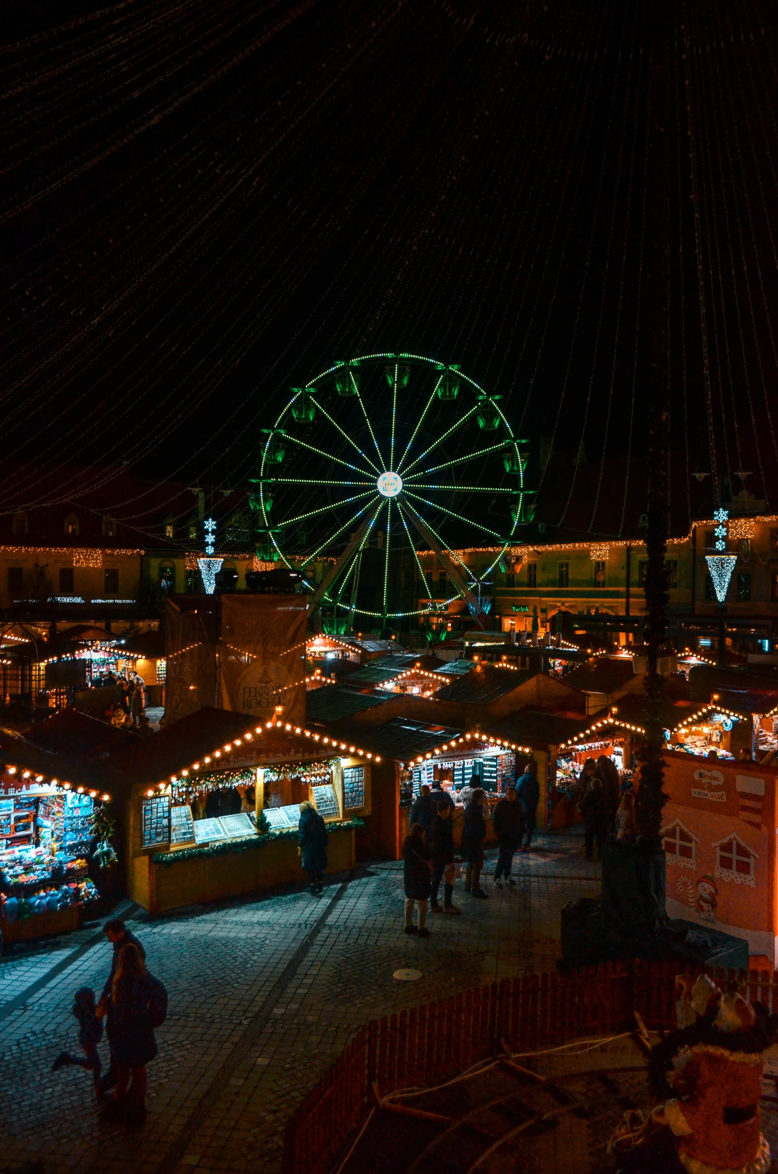 a christmas market at night has colorful lights