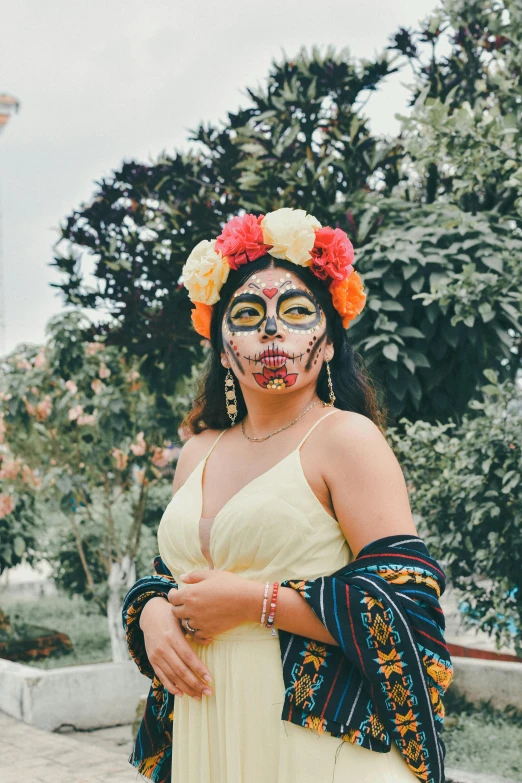 a woman wearing a mask with flowers on her head