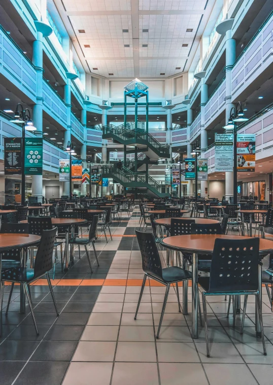 an indoor seating area for large dining tables with metal chairs and tables