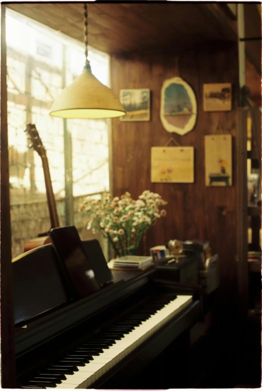 a black piano sitting in front of a window