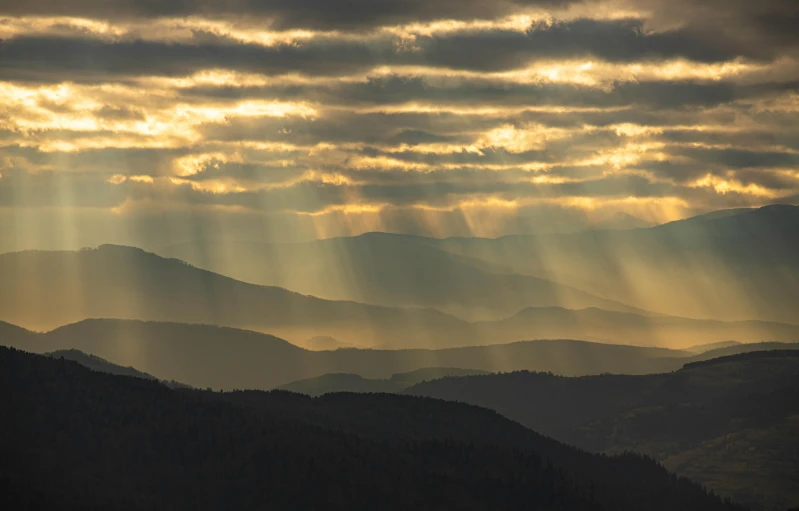 some mountains and clouds in the sky