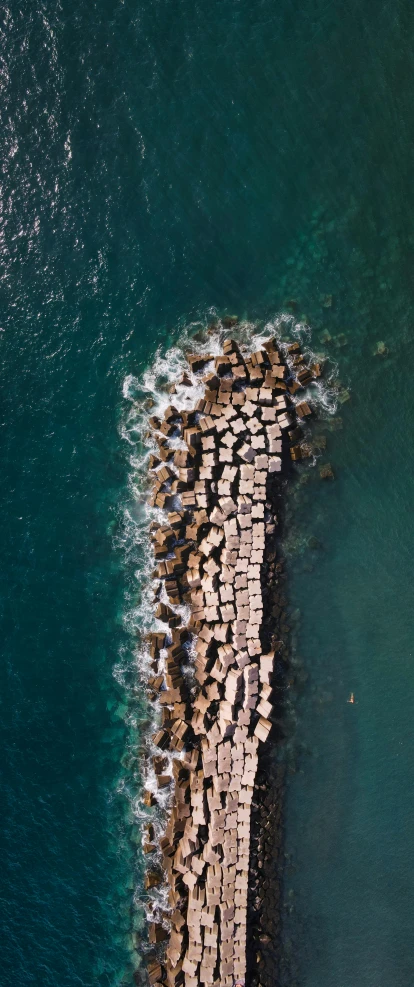 an aerial view of a dock in the ocean