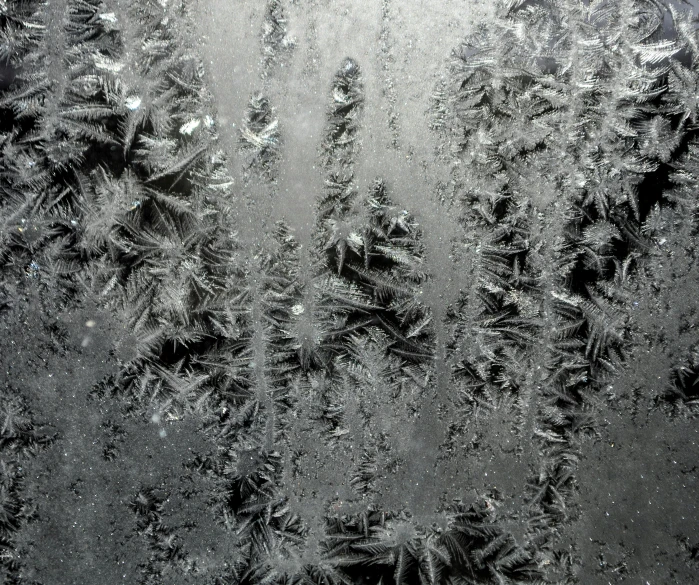 a frosty window with snow flakes and drops