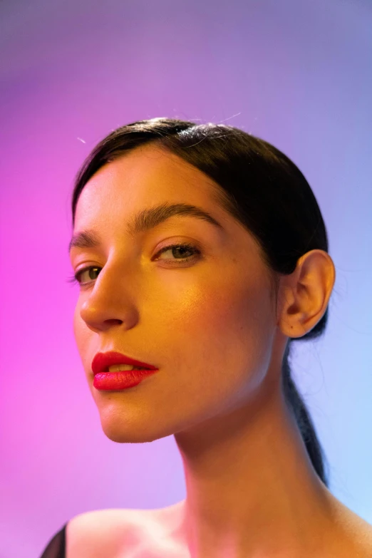 a woman with a bright red lipstick looking at the camera