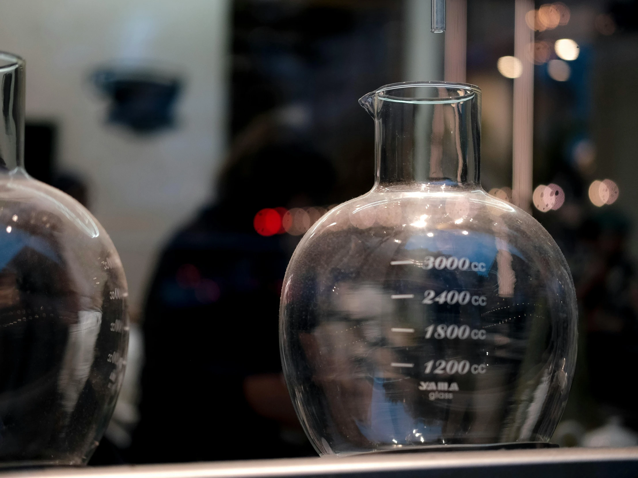 a pair of glass vases on display on a shelf