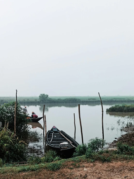 a boat is docked on a small lake