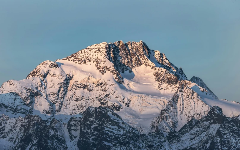 a snow covered mountain with a sky background